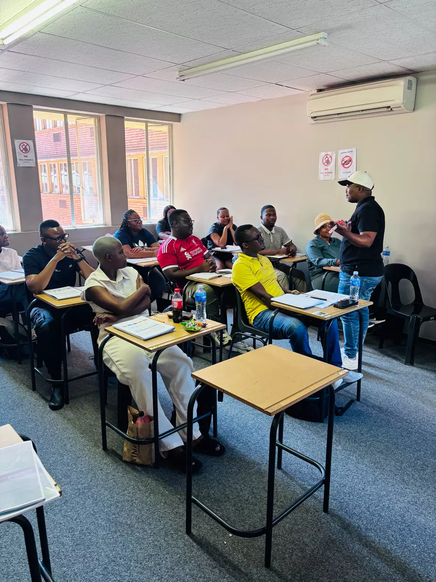 Instructor leading a group of adult students in a classroom